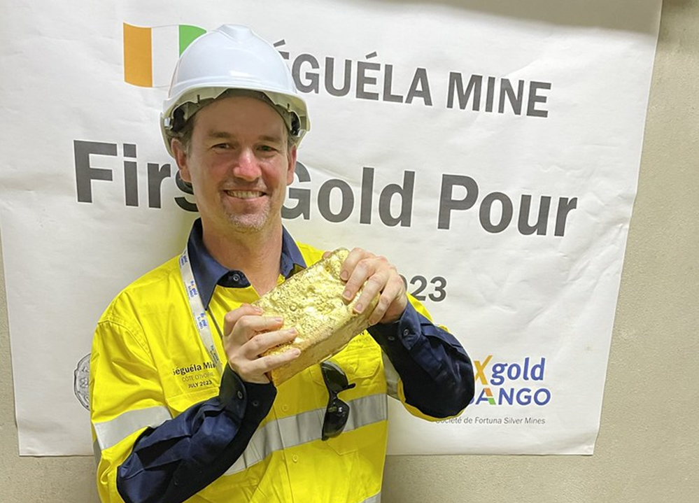 Justin Tolman in the Cote d’Ivoire holding a freshly poured gold bar from a new gold mine.